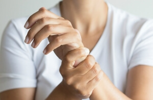 Разминает руку после перелома